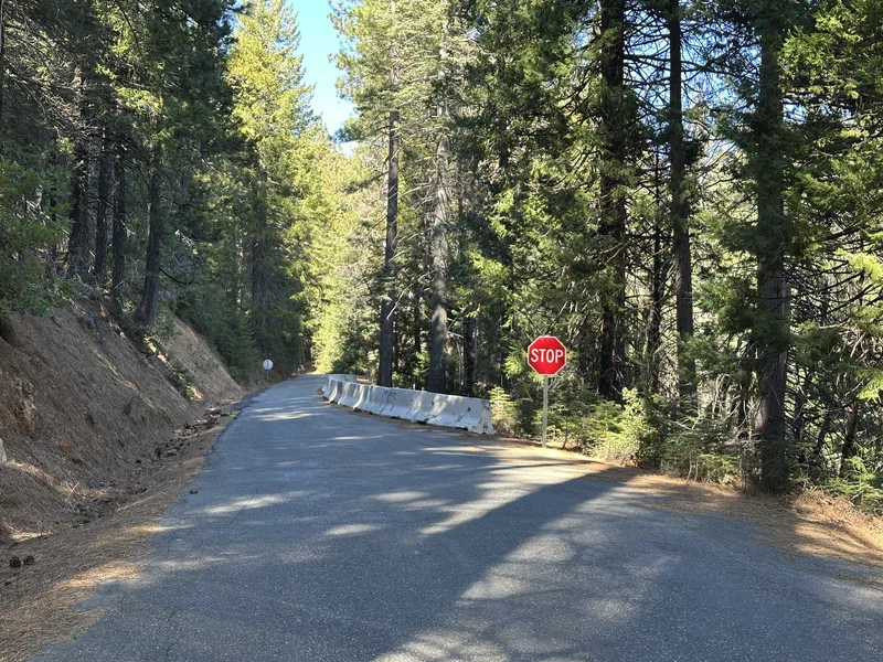 A stop sign beside the Skyway at the near end of the barrier-lined section